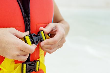 Child buckling his life vest